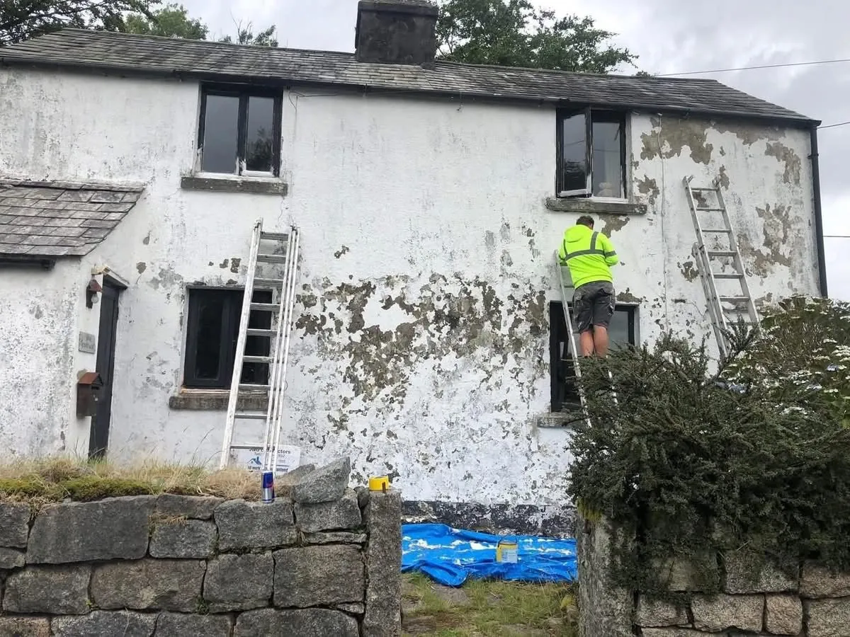 Cottage with blown, flaking render before repair in Okehampton